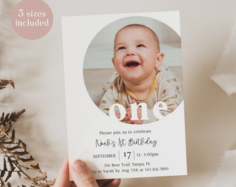May include: A white invitation card featuring a photo of a baby within a circle. The word "one" is displayed in large white letters on the card. Below the photo, the text reads "Please join us to celebrate Noah's 1st Birthday". The date and time of the party are listed beneath the text. The address and RSVP details are at the bottom of the card.