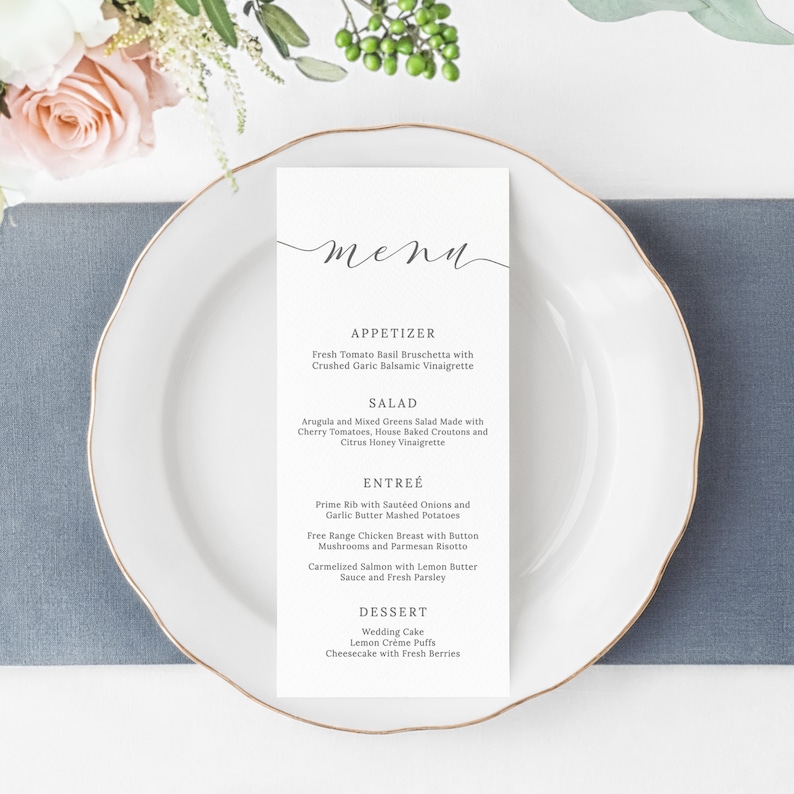May include: A white menu card with a handwritten 'menu' title. The menu lists appetizers, salad, entree, and dessert options. The menu items are written in a simple, elegant font.