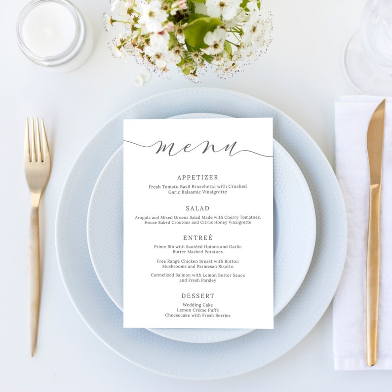 May include: A white menu with a gray script font title "menu". The menu lists appetizers, salad, entree, and dessert options. The menu is on a light blue plate with a gold fork and knife.