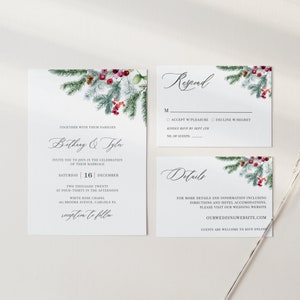 May include: A set of wedding stationery with a winter theme. The invitation, RSVP, and details cards feature a watercolor design of pine branches, red berries, and greenery. The invitation includes the names "Bethany & Tyla" and the date "16 December".