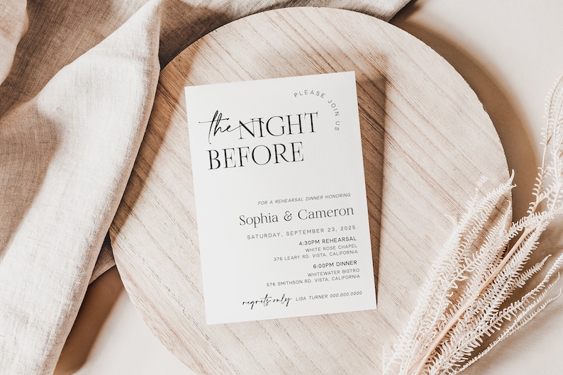 May include: A white card with black text announcing "The Night Before" for a rehearsal dinner honoring Sophia & Cameron on Saturday, September 23, 2026. The card lists the time and location for the rehearsal and dinner.