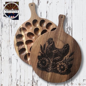 May include: A wooden serving board with a chicken design and a separate section with 18 egg-shaped indentations.