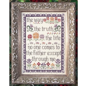 Puede incluir: Un bordado de punto de cruz enmarcado con fondo blanco y borde morado. El bordado presenta un diseño floral con flores de colores y el texto "the way the truth the life no one comes to the Father except through me".