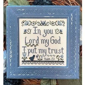 May include: A framed cross-stitch embroidery with a blue frame and a white background. The embroidery reads "In you Lord my God I put my trust" and "Psalm 25:1".