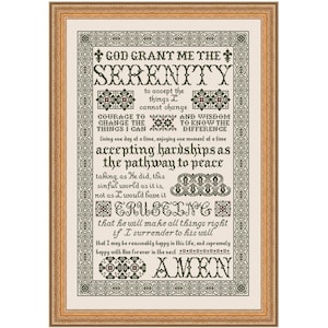 May include: A framed cross-stitch artwork with a gold-colored frame. The artwork features the text "GOD GRANT ME THE SERENITY" and other inspirational phrases in black thread on a cream-colored background. The frame measures approximately 18 x 12 inches.