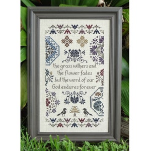 May include: A framed cross-stitch embroidery with a floral design and the text "the grass withers and the flower fades but the word of our God endures forever".