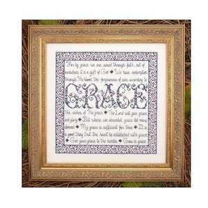 May include: A framed cross-stitch embroidery featuring the word "GRACE" in large letters. The embroidery includes a quote about grace from the Bible: "For by grace we are saved through faith, not of ourselves, it is a gift of God. We have redemption through His blood, the forgiveness of sins, according to the riches of His grace. The Lord will give grace and glory. But where sin abounded, grace did more abound. My grace is sufficient for thee. It is a good thing that the heart be established with grace. God gives grace to the humble. Grow in grace."