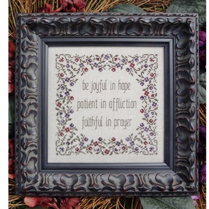 May include: Framed cross-stitch embroidery with a floral border and the text "be joyful in hope patient in affliction faithful in prayer".