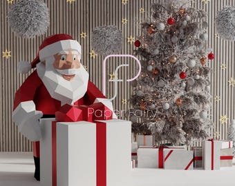 May include: A papercraft Santa Claus figure holding a large red and white gift box with a red ribbon. The figure is standing in front of a Christmas tree decorated with red, white, and gold ornaments. The background is a wood panel wall with white fluffy balls and gold stars.
