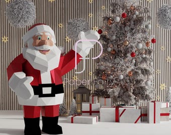 May include: A red and white papercraft Santa Claus figure stands with his arm raised, waving. He is next to a snowy Christmas tree decorated with red and white ornaments. The background is a wood-paneled wall with white fluffy balls hanging from the top.