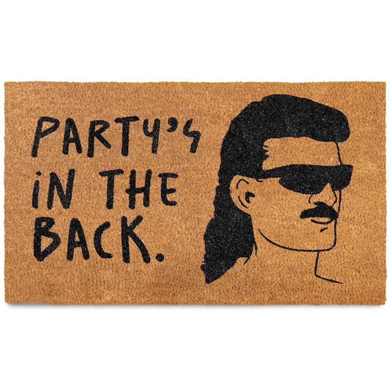 May include: A brown doormat with the text "PARTY'S IN THE BACK." in black lettering. A cartoon illustration of a man with a mullet, sunglasses, and a mustache is on the right side of the doormat.