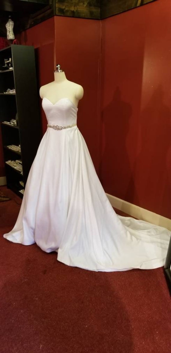 wedding gown with sweetheart neckline, ballgown, box pleated skirt, cathedral train and beaded sash. wedding gown with sweetheart neckline, ballgown, box pleated skirt, cathedral train and beaded sash.