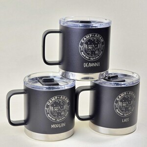 Personalized Camp Adam tumbler mugs, set of 3, black stainless steel with clear lids. Custom engraved with names, '30' milestone, and camping graphics. Perfect for campers, outdoor enthusiasts, and milestone celebrations.