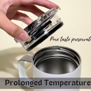 White insulated travel mug with silver lid, featuring Pure taste preservation and Prolonged Temperature text. Perfect for hot or cold beverages, travel, and daily use.