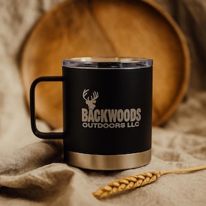 Black stainless steel insulated mug with Backwoods Outdoors LLC logo and antler graphic. Insulated tumbler for hot or cold drinks.