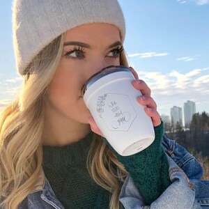 Personalized insulated tumbler with floral engraving and What's yours will find you quote. White, metallic lid. Perfect for hot or cold drinks, travel, gift.