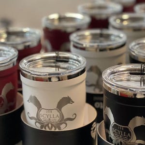 Scylla Animation Team custom tumblers. Insulated stainless steel travel mugs in red, white, and black. Perfect for hot or cold drinks. Show your team pride!