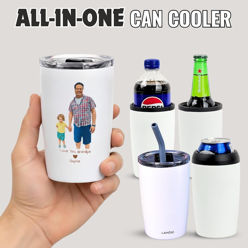 A person's hand holding a white cup with a printed image of a man and a child, along with a can cooler and a bottle of soda.