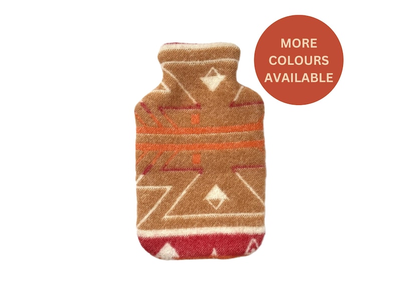 Front view of brown geometric wool hot water bottle cover with “More colours available” badge on white