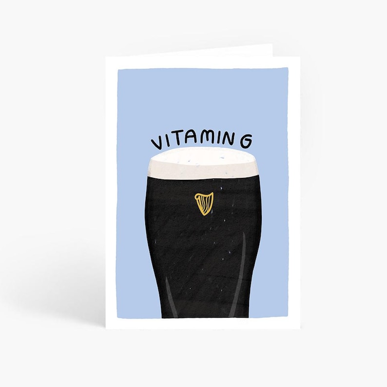May include: A blue greeting card with a black and white illustration of a pint of Guinness with the text "VITAMING" above it.