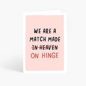 May include: A pink card with the text "We are a match made in heaven" with the word "heaven" crossed out and the words "on hinge" written below.