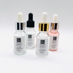 May include: Four small glass bottles with dropper tops containing car diffuser refills. The bottles are labeled "Savvy Lady Kndles" and have different scents: Pink Sugar Crystals, Bamboo & Coconut, Bamboo & Coconut, and Blackberry & Coconut. Each bottle is 10 ml.