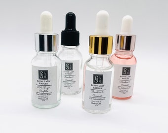 May include: Four small glass bottles with dropper tops containing car diffuser refills. The bottles are labeled "Savvy Lady Kndles" and have different scents: Pink Sugar Crystals, Bamboo & Coconut, Bamboo & Coconut, and Blackberry & Coconut. Each bottle is 10 ml.