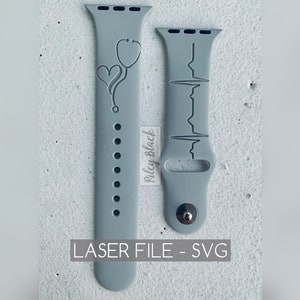 May include: Two gray silicone watch bands with laser-cut designs. One band features a stethoscope and heart, the other features a heartbeat line.  "LASER FILE - SVG" is printed below the bands.