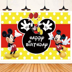 May include: A yellow and red backdrop with white polka dots features a black and white Mickey Mouse head with the words "Happy Birthday" in white. Two Mickey Mouse characters are on either side of the head, one in red and one in black.