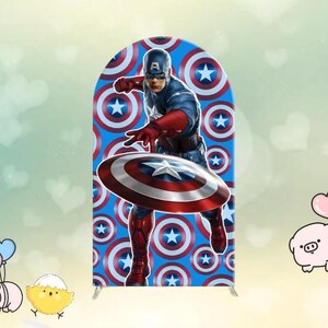May include: A Captain America-themed arch-shaped backdrop featuring the superhero in action, holding his iconic shield. The background is a repeating pattern of blue circles with white stars. The character is dressed in a blue, red, and white costume.