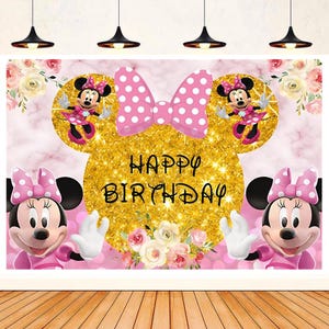 May include: A pink and gold birthday banner with a Mickey Mouse character and the words "Happy Birthday".