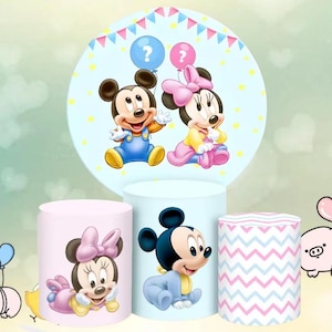 May include: A set of three ceramic mugs with a speckled, cream-coloured glaze. Each mug features a different hand-painted design: a blue and green leaf, a yellow flower, and a red berry. The mugs have a simple, modern design.