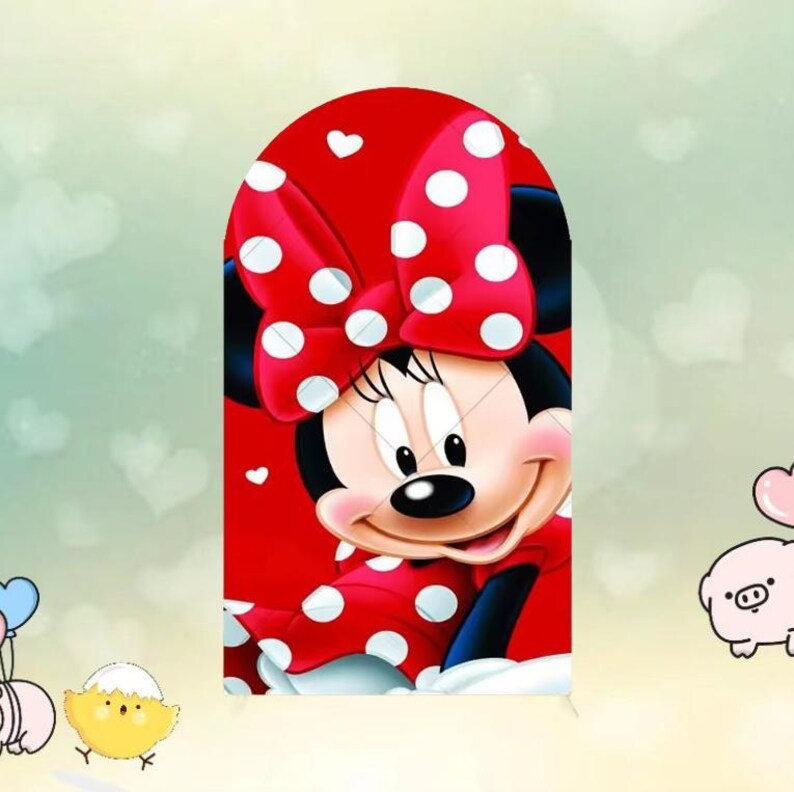 May include: A cartoon illustration of Minnie Mouse, featuring a red dress with white polka dots and a matching bow. The background is a light green with white heart shapes. Minnie Mouse is smiling.