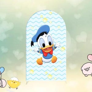 May include: A blue and white backdrop with a cartoon duckling wearing a blue sailor hat. The backdrop has a chevron pattern with white stars.