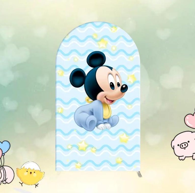 May include: A blue and white baby shower backdrop with a cartoon baby Mickey Mouse wearing a blue onesie and a yellow bib. The backdrop has a wavy pattern with white stars.
