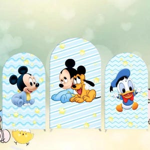 May include: Three blue and white arch-shaped cardboard backdrops with a blue and white striped pattern and yellow stars. The backdrops feature cartoon characters Mickey Mouse, Pluto, and Donald Duck.