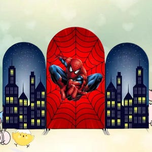 May include: A three-panel backdrop featuring Spider-Man. The central panel has a red spiderweb design with Spider-Man in a dynamic pose. The side panels depict a cityscape at night with a dark blue sky and illuminated buildings. The backdrop is designed for events.