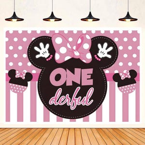 May include: Pink and black Minnie Mouse themed backdrop with white polka dots and pink and white stripes. The backdrop features a large Minnie Mouse head with a pink bow and the text "ONE derful".
