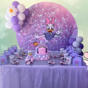 May include: A purple and white birthday party table setting with a two-tiered cake decorated with a cartoon duck, a purple and white backdrop with a cartoon duck, and purple and white party favours.