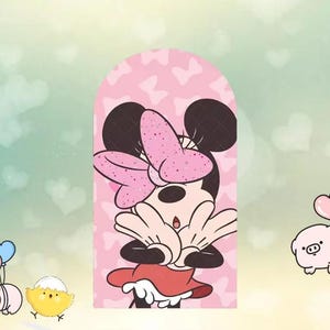 May include: A pink, arched-shaped illustration of Minnie Mouse with a large pink bow and red dress. The background is light pink with heart shapes. The cartoon character is covering her mouth with her hands.