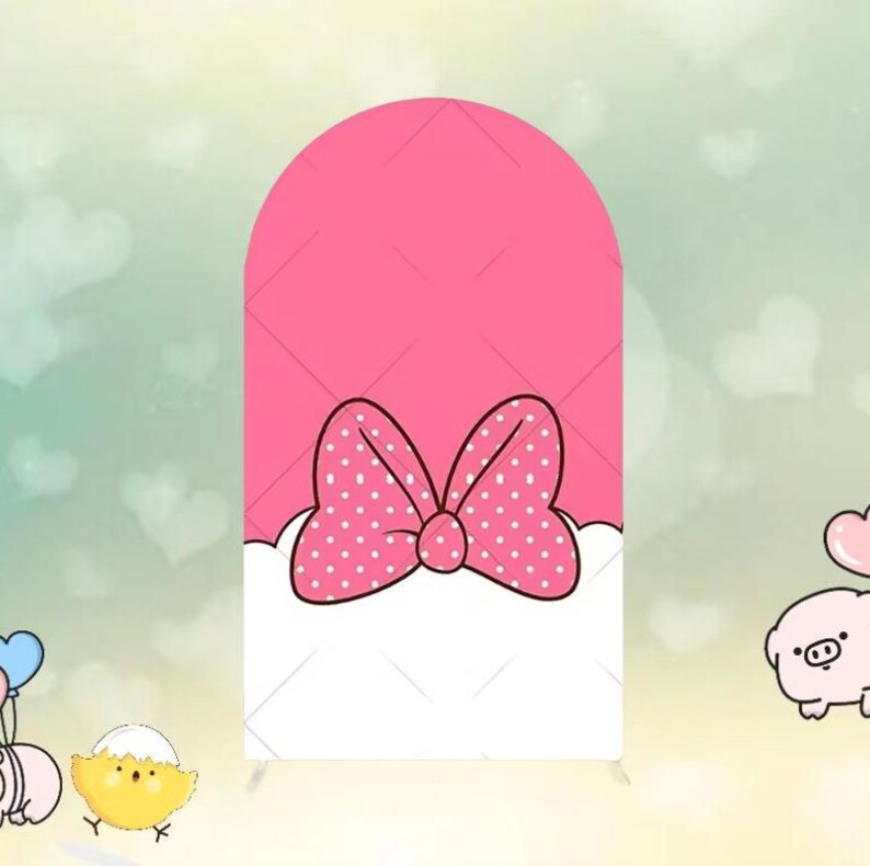 May include: A pink backdrop with a large bow design. The bow is white with pink polka dots. The backdrop has a pink top section and a white bottom section. The background is light green with white hearts.