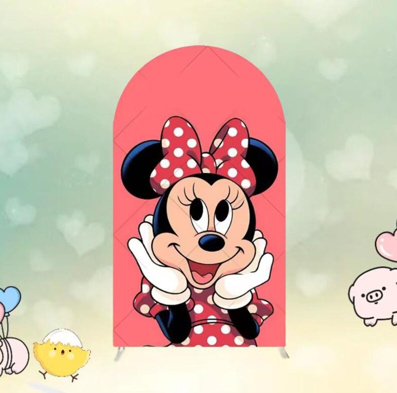 May include: A decorative arch featuring a cartoon image of Minnie Mouse. Minnie Mouse is wearing a red dress with white polka dots and a matching bow. The background is a light pink color.