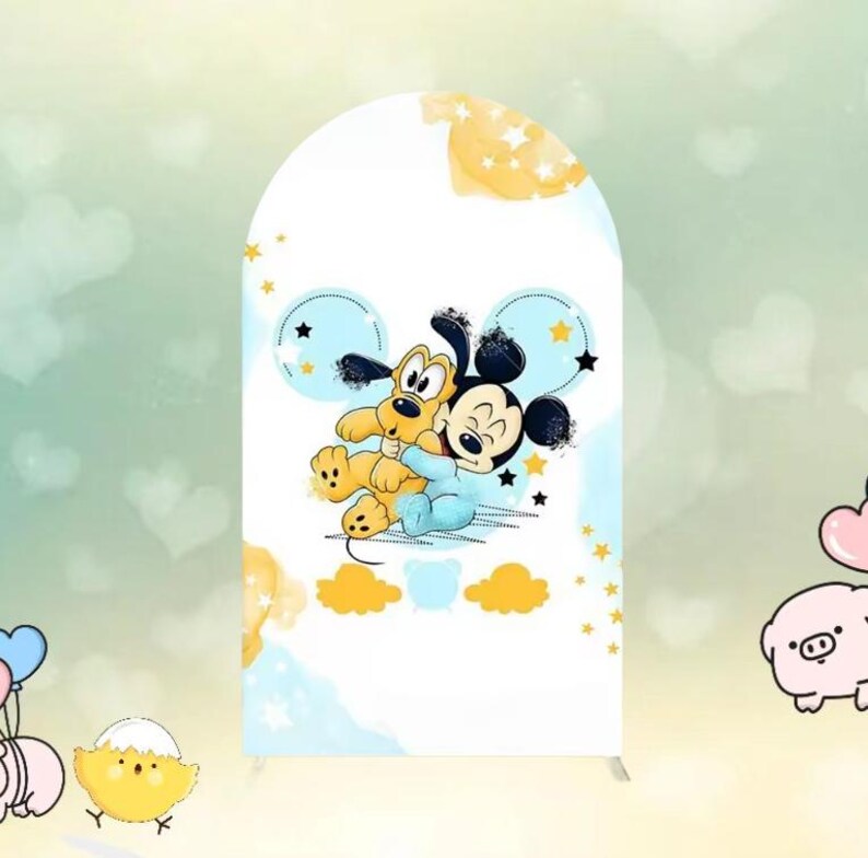 May include: A white arch-shaped backdrop featuring a cartoon illustration of Mickey Mouse and Pluto hugging. The design includes blue and yellow accents with stars and clouds. The backdrop is suitable for a party or event.