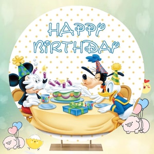 May include: A white and yellow polka dot backdrop with the words "Happy Birthday" in blue. Mickey Mouse, Donald Duck, and Goofy are celebrating with a cake and a gift.
