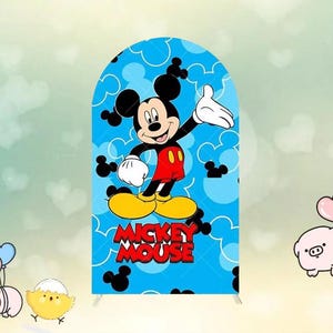 May include: A blue backdrop featuring Mickey Mouse. The cartoon character is in the center, with a red shirt, yellow shoes, and white gloves. The words "Mickey Mouse" are in red. The background is light blue with white Mickey Mouse silhouettes.