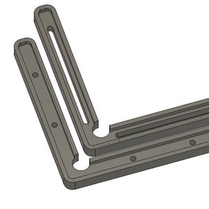 May include: A grey plastic corner brace with two slots for joining pieces of wood together.