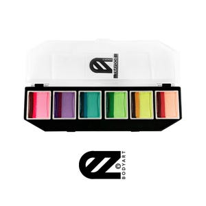 Puede incluir: Una paleta de 6 pinturas corporales vibrantes en una caja negra y blanca. Los colores son rosa, morado, verde azulado, verde, amarillo y naranja. La caja tiene el logotipo "BODYART".