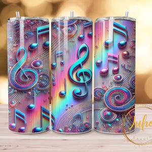 May include: Three stainless steel tumblers with a vibrant, colourful design featuring musical notes and treble clefs. The design incorporates shades of blue, pink, and purple, creating a whimsical and artistic aesthetic. Each tumbler has a straw.