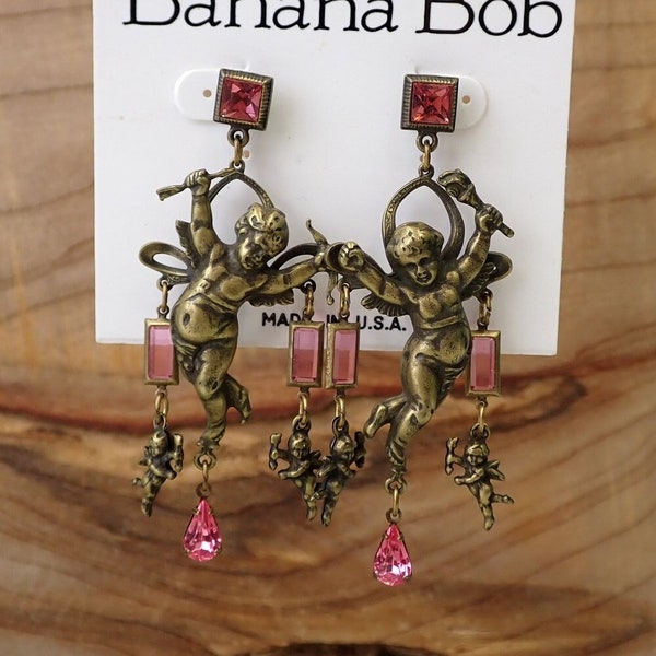 Vintage Banana Bob cupid earrings, 80s cherub dangle earrings, brass tone with pink stones, baroque fashion style, catwalk costume jewelry