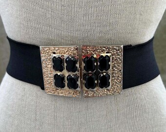 80s black elastic belt, bejeweled rectangular gold tone buckle, sophisticated maximalist fashion, stage accessories, glam rock chica
